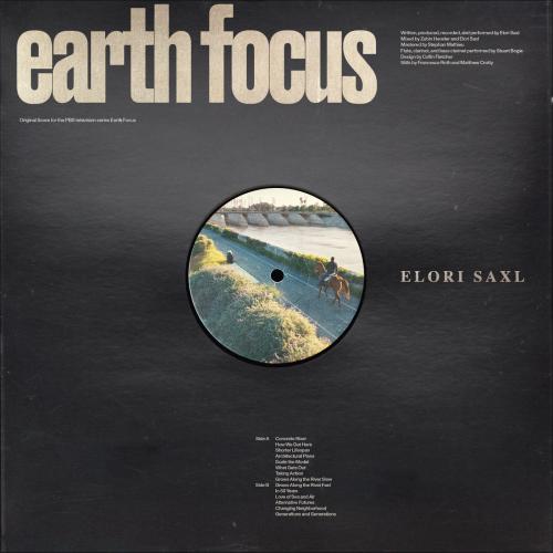 earth focus title set on a black background, where in the middle of the album art there is a person riding a horse riding on a pathway inbetween a grassy hill off to the left and a waterway off to the right.